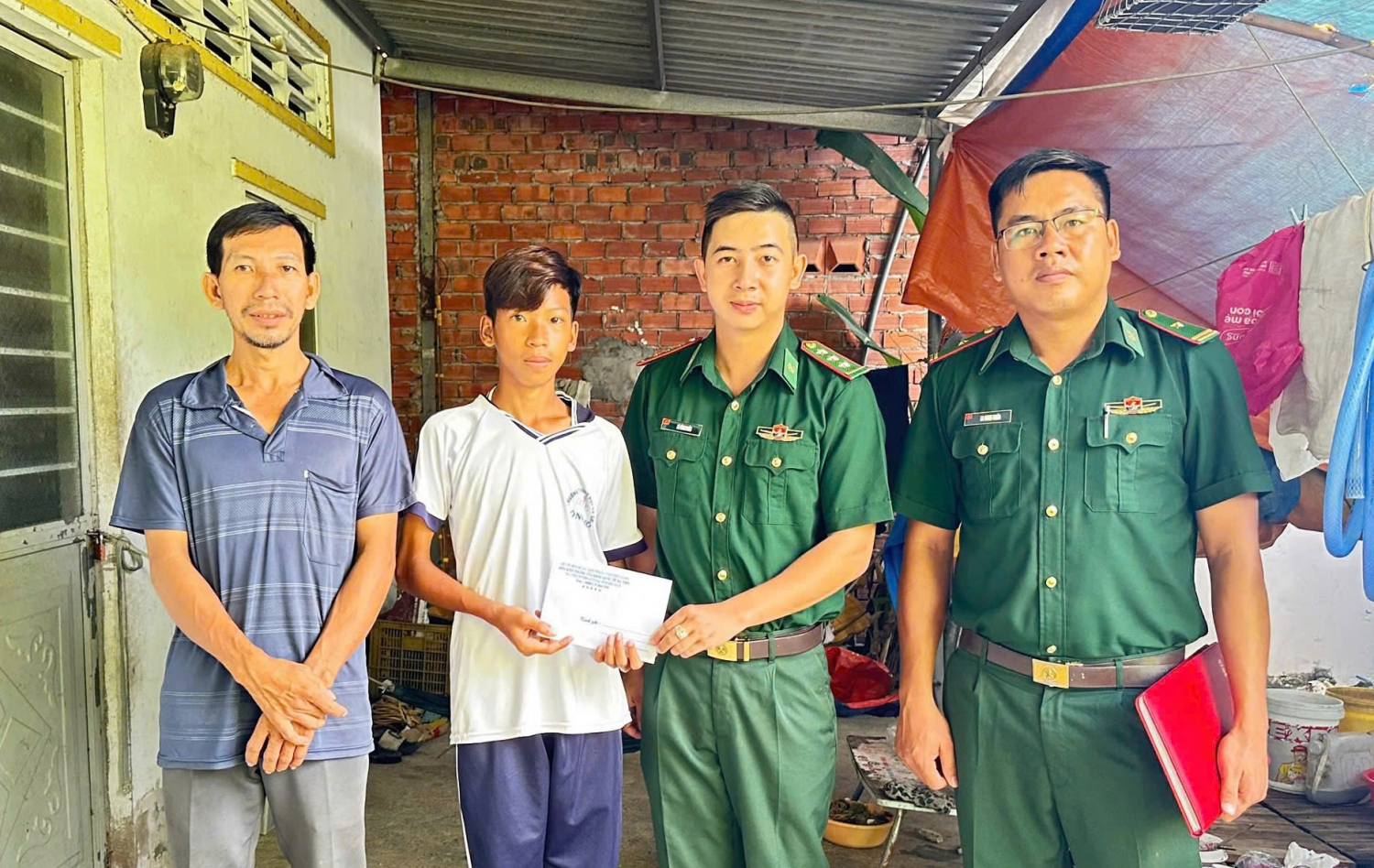 Đồn Biên phòng cửa khẩu quốc tế Hà Tiên trao tiền hỗ trợ cho học sinh nghèo trong Chương trình “Nâng bước em tới trường”.